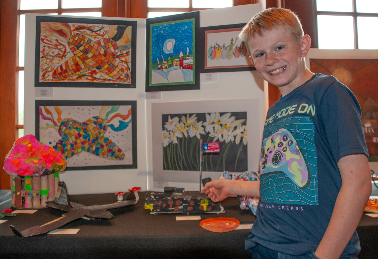 Sullivan West Elementary school's Jace Steffans was all smiles while posing with his Popsicle-stick sculpture at the Sullivan County-Wide PK-12 art show, held at Bethel Woods last weekend.